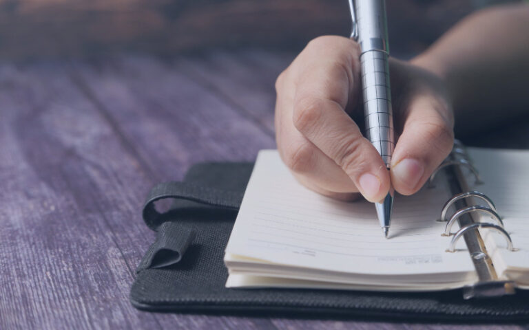Person taking notes in a notepad