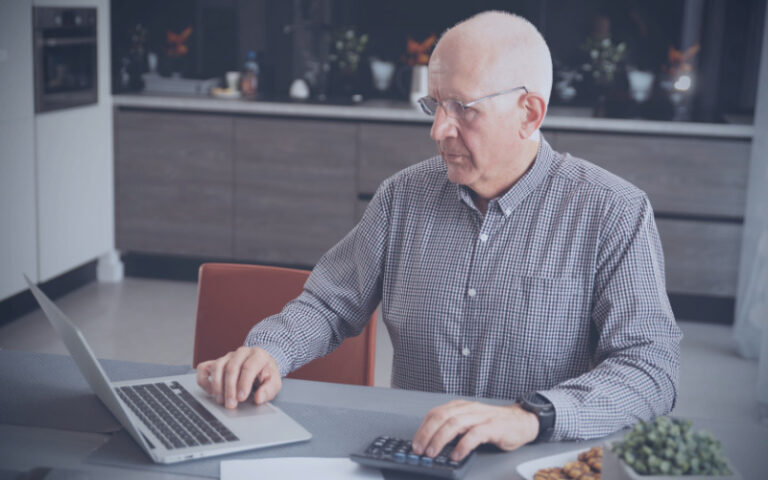 Older man at laptop in home