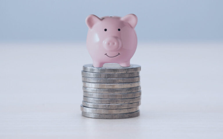 Piggy on top of pile of coins