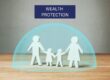 Cut out paper family surrounded by a protective bubble