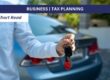 Man handing car keys with car in background