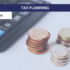 Calculator next to 3 piles of coins