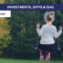 Girl swinging on a swing in front of green trees